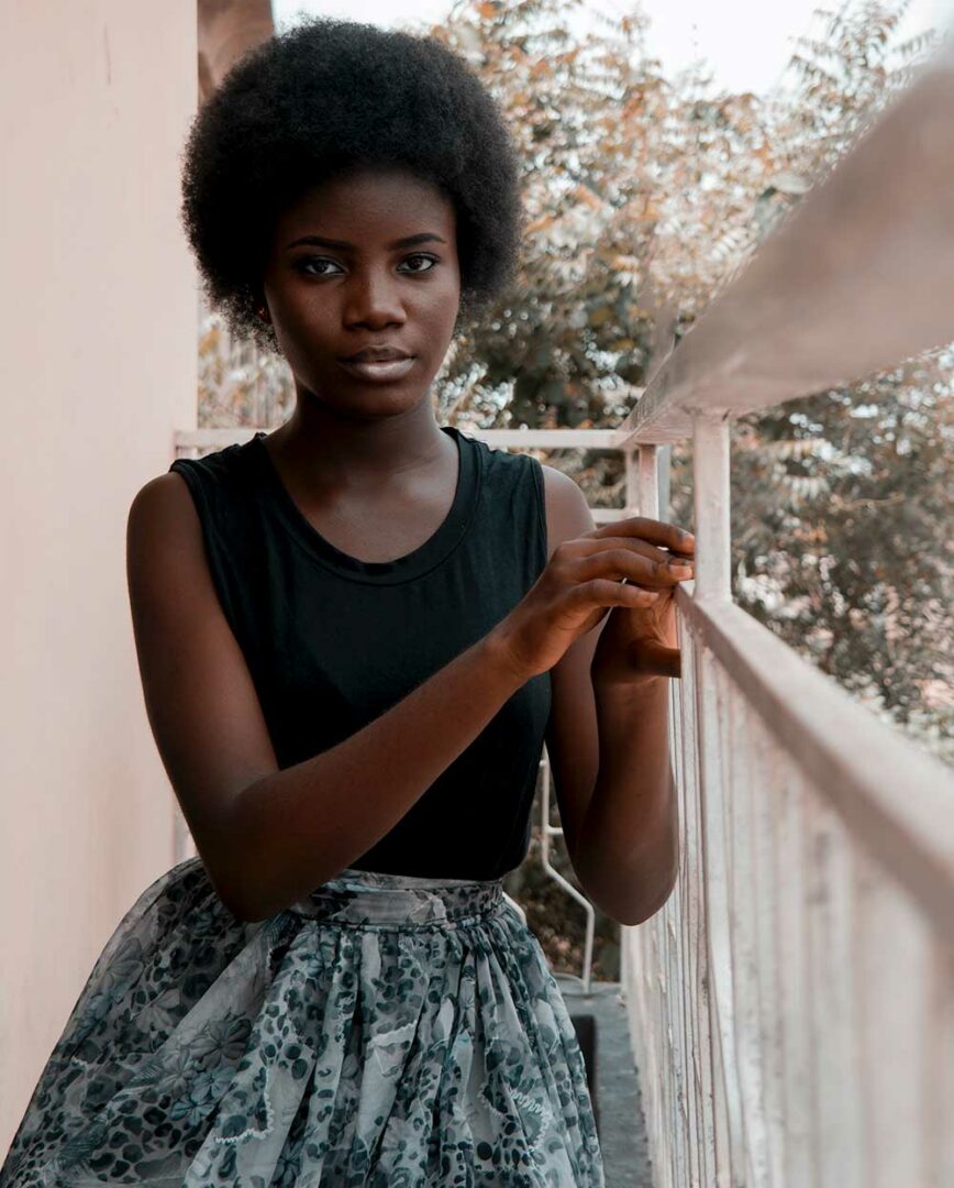 Girl with an afro showing how to care for 4c hair