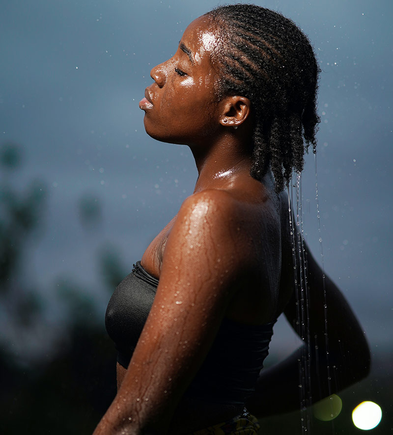 Woman in rain with wet hair to show the maximum hydration method