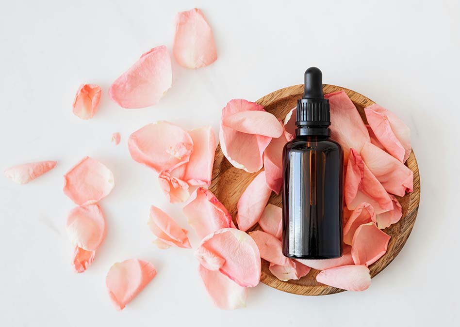 Rose oil for hair on a table showing how it can become part of your hair regime.